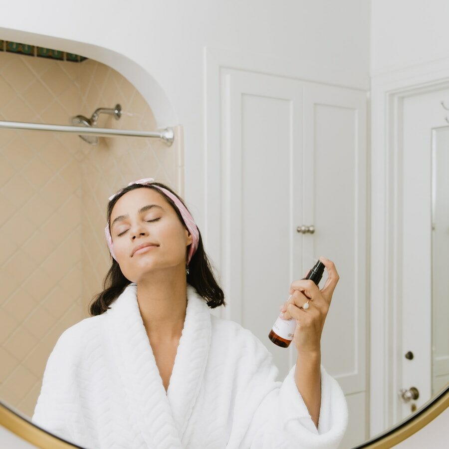 woman in white bathrobe holding smartphone